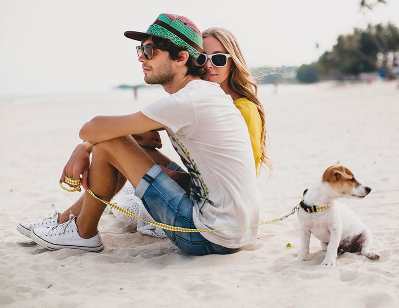 Couple with dog on beach-tripgalapagos.com